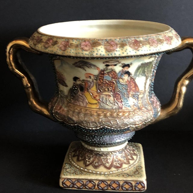 Nice vase with golden handles to decorate small spaces. This piece is attributed to the mentioned designer/maker. It has...