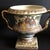 Nice vase with golden handles to decorate small spaces. This piece is attributed to the mentioned designer/maker. It has...