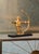 Cast composite in gold leaf on black mounting 14h x 13w x 6d