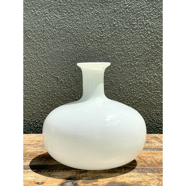 This elegant vintage glass vase perfectly captures the serene minimalism of Mid-Century Modern design. Crafted from high-...