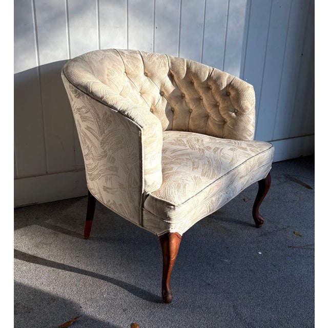 1950s-60s cream brush-print tufted barrel chair w/ carved wood legs. Some minor fading on armrest portion of chair as...