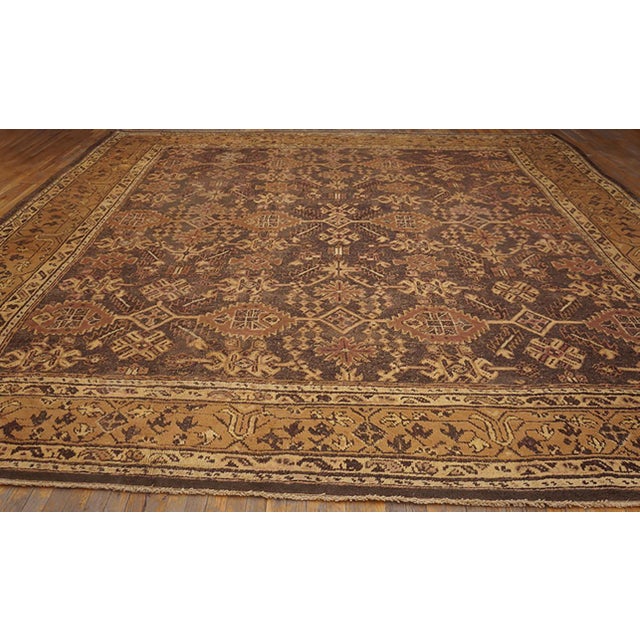 Antique Oushak Room Size Wool Brown Rug, Circa Date: 1920s. This magnificent example of Anatolian weaving tradition...