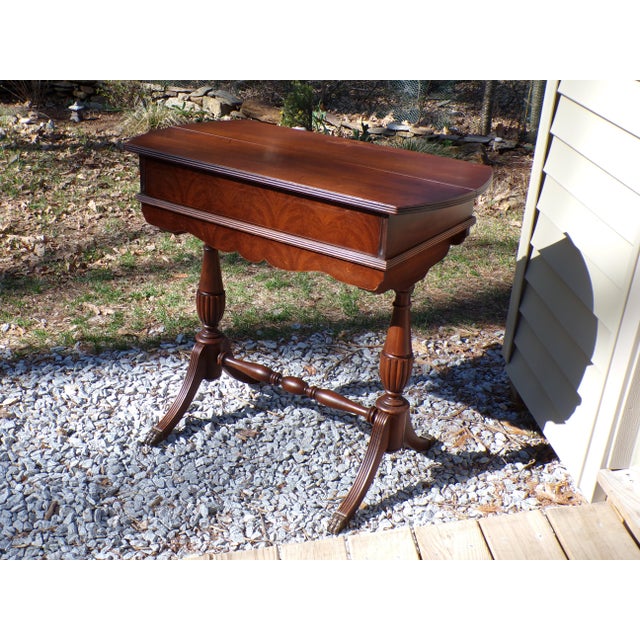 Vintage Duncan Phyfe style Spinet Desk features one drawer below a a top that lifts and folds back to reveal a pull out...