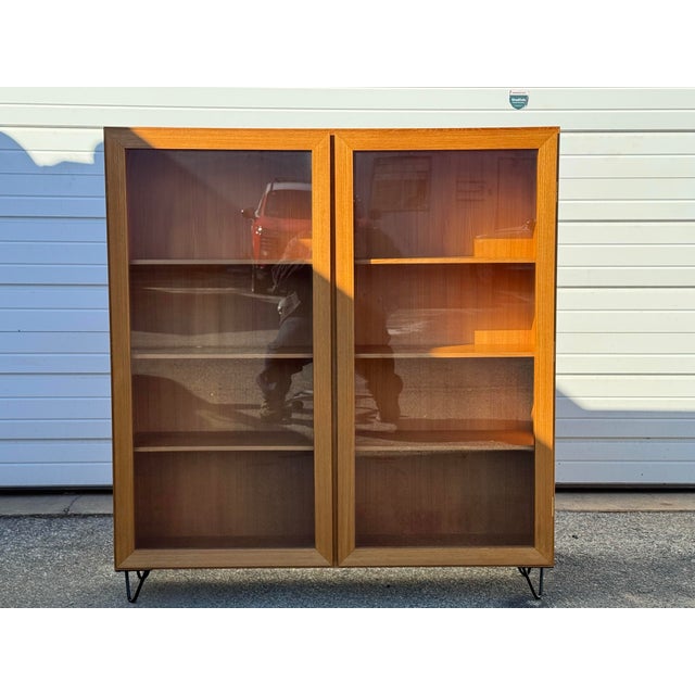 Mid Century Danish Modern Teak Bookcase Offered is a Mid Century Danish Modern Teak 2 Door Bookcase. It has two separate...