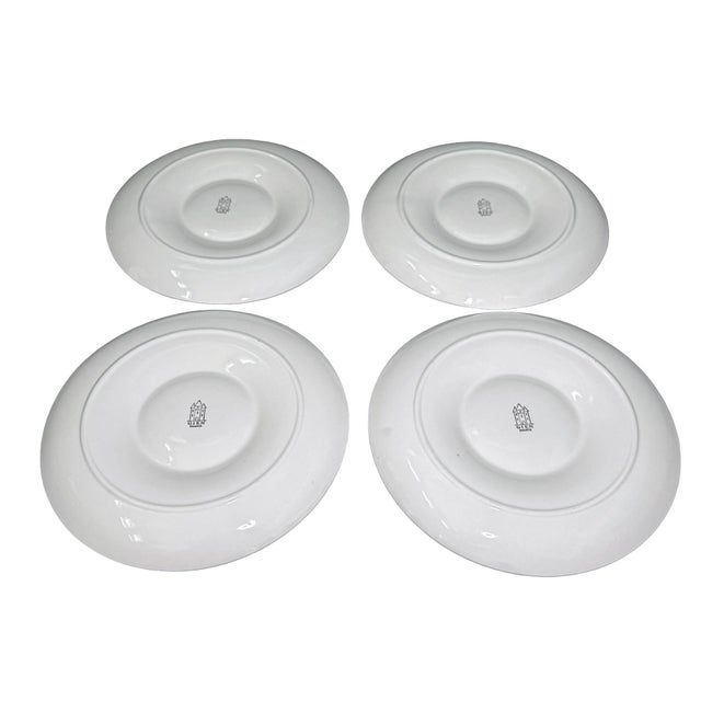A sculptural set of four white artichoke plates by Gien France, made for the ritual of serving a whole artichoke with room...