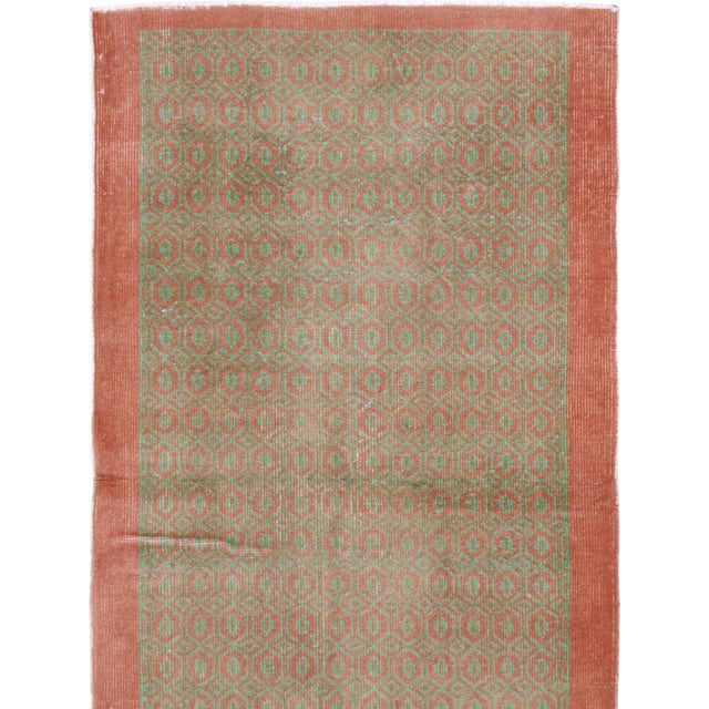 This mid-20th-century Turkish Anatolian runner presents a refined allover design composed of tightly repeated oval and...