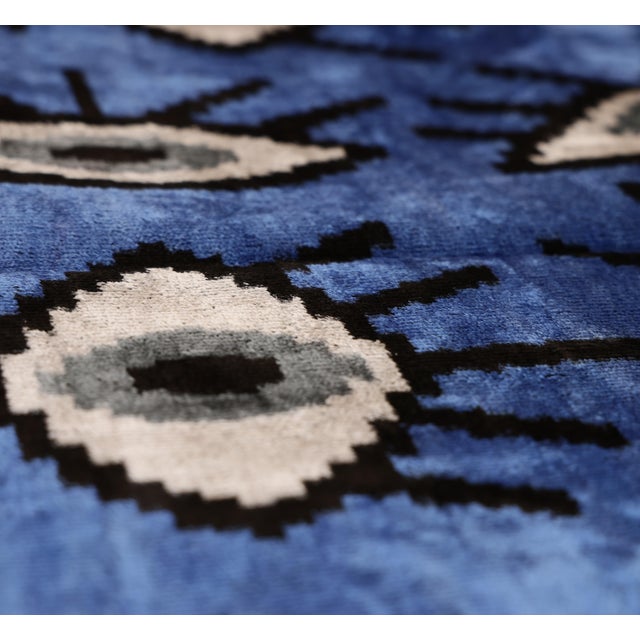 "A bold expression of modern Ikat artistry, this handmade velvet pillow features a rich cobalt blue field layered with...