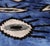 "A bold expression of modern Ikat artistry, this handmade velvet pillow features a rich cobalt blue field layered with...