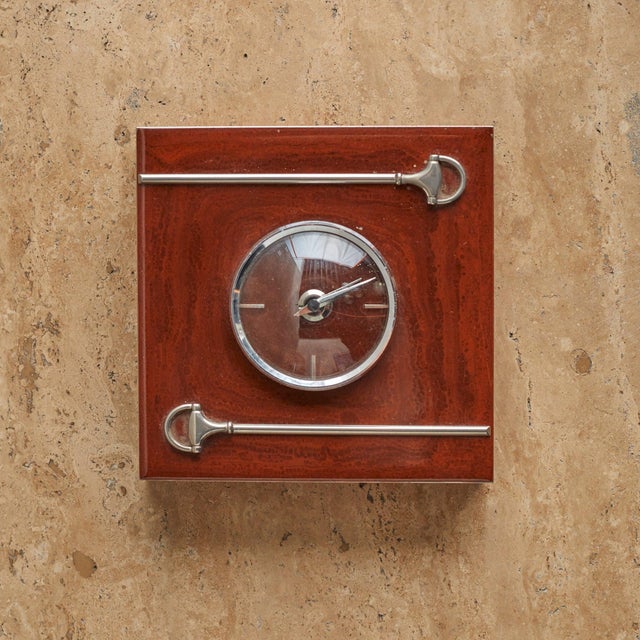 This 1970s Gucci desk clock showcases the brands signature equestrian influence. The design pairs warm-toned wood with...