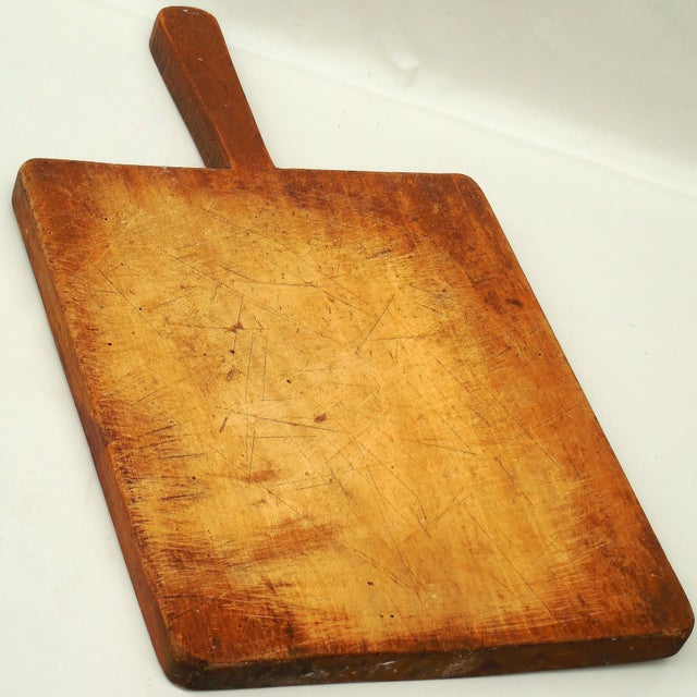 An authentic 19th-century primitive bread board or chopping block, hand-carved from a single piece of dense beechwood....