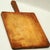 An authentic 19th-century primitive bread board or chopping block, hand-carved from a single piece of dense beechwood....