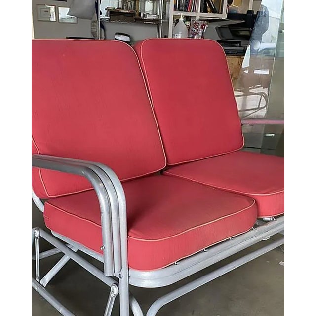 Post-war outdoor patio aluminum Slider Settee With double Poles Armrest. This Mid-century patio/outdoor settee consists of...