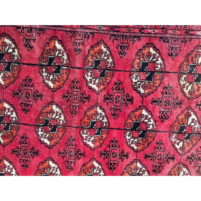 Nice mid century Turkmen rug with a Bokhara design and a red field with black, orange and white. Some wears, and loses at...