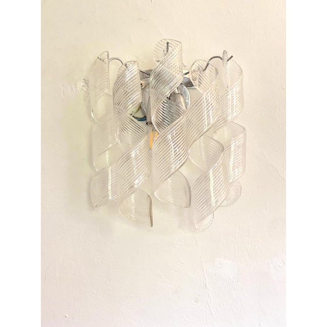 Transparent vintage “CURLS” wall sconces. “RICCIO” is a glass element of hight italian handcraftsman made in Murano. A...
