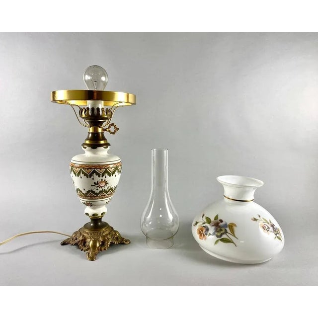 Large Vintage Table Lamp with two shades. Hand painted colorful flowers with leaves bloom from a vintage table lamp. The...