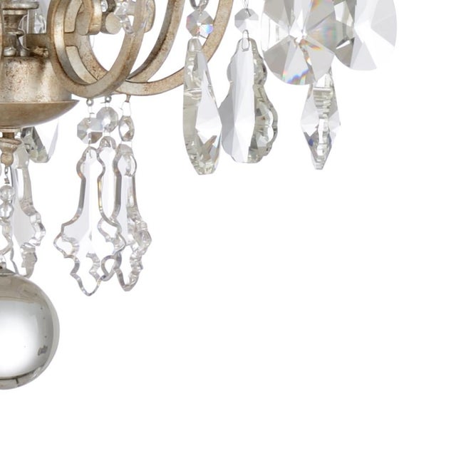 Antique silver leaf finish on 12 light chandelier with clear crystals. Comes with 9 feet of chain. 46h x 34w x 34d