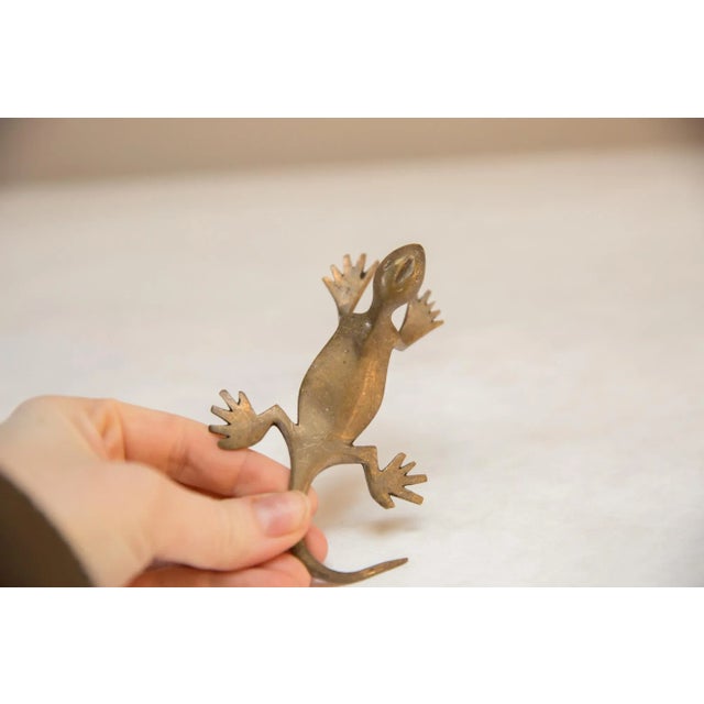 Vintage handmade African bronze gold patina gecko. Circa mid 20th century and possibly older, this piece has such...