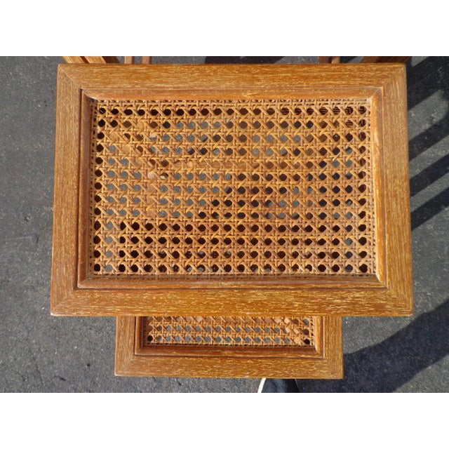 Quality set of nesting tables crafted from solid, real wood and woven cane inserts. Features a rich, golden finish and...