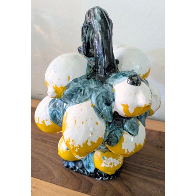 A striking vintage Italian majolica ceramic pitcher crafted in the form of an overflowing basket of lemons, richly...