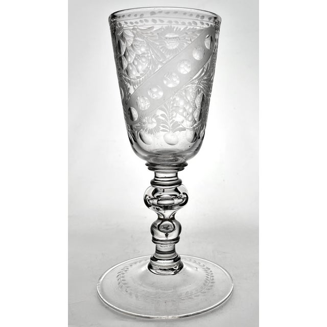 An impressive hand blown and hand engraved 18th century goblet, having a stunning stem made of several separately fused...