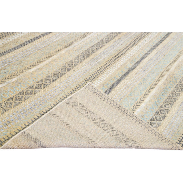 Beautiful modern Apadana's Safi Collection hand-knotted wool rug with a beige color field. This Modern rug has blue,...