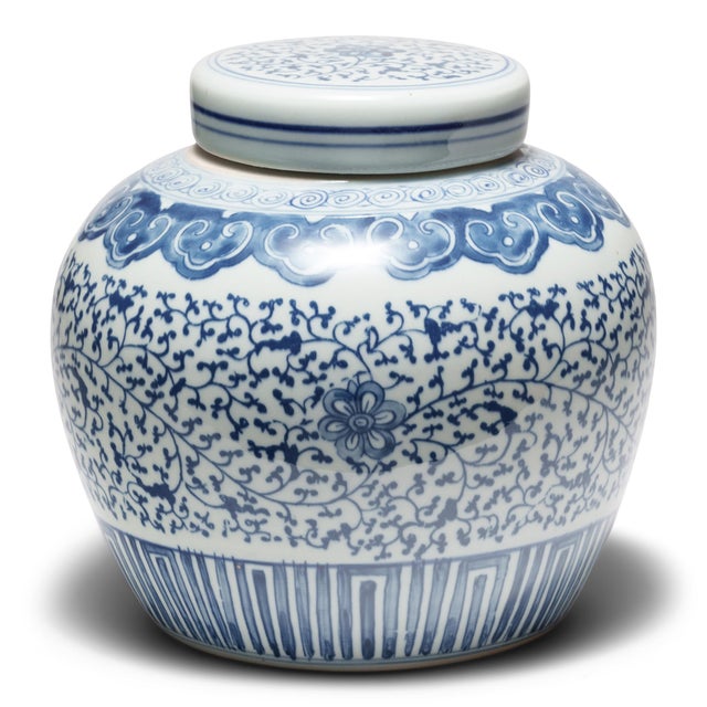 This round, porcelain ginger jar is brightly glazed in the blue-and-white manner. A combination of stenciled linework and...