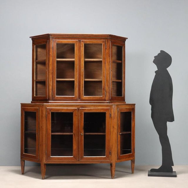 Double-bodied walnut sideboard, notched. The door panels on the base and top have been replaced with glass, with brass-...