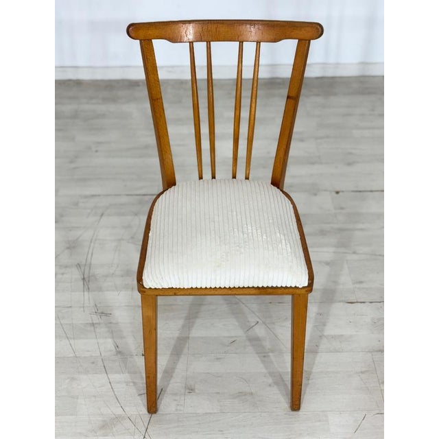 For sale is a set of four mid-century dining chairs from the 1960s. The chairs have been reupholstered and are in...