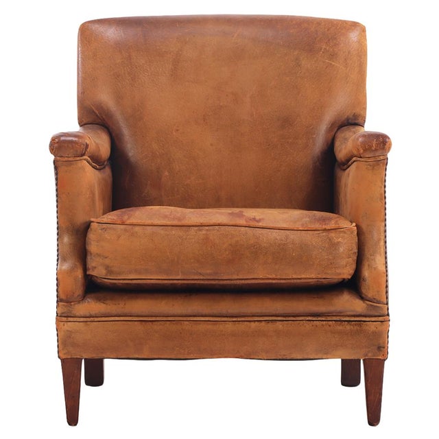 The deeply proportioned, low-slung architectural frame is fully hand-upholstered in its original, heavily patinated...