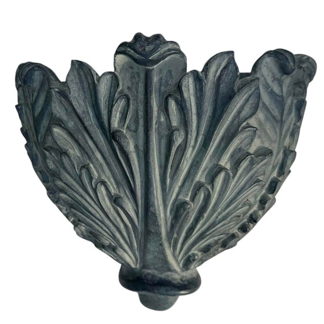 A decorative wall pocket planter featuring an elegant acanthus leaf design with a beautifully aged verdigris finish....