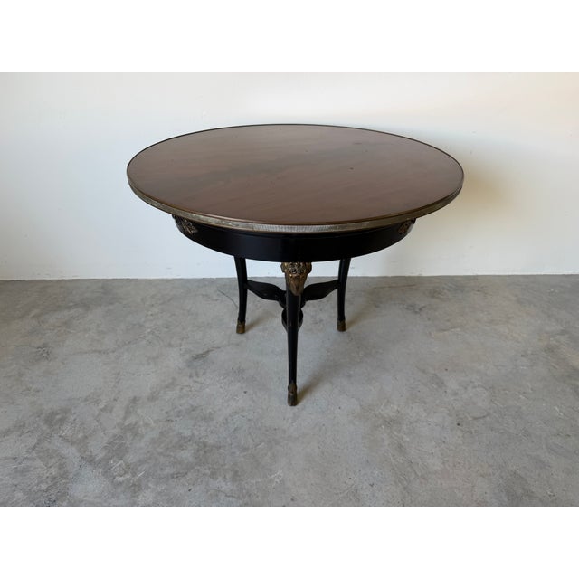 Elegant vintage Baker French Regency style accent table, featuring a rich wood top with a brass gallery edge and striking...