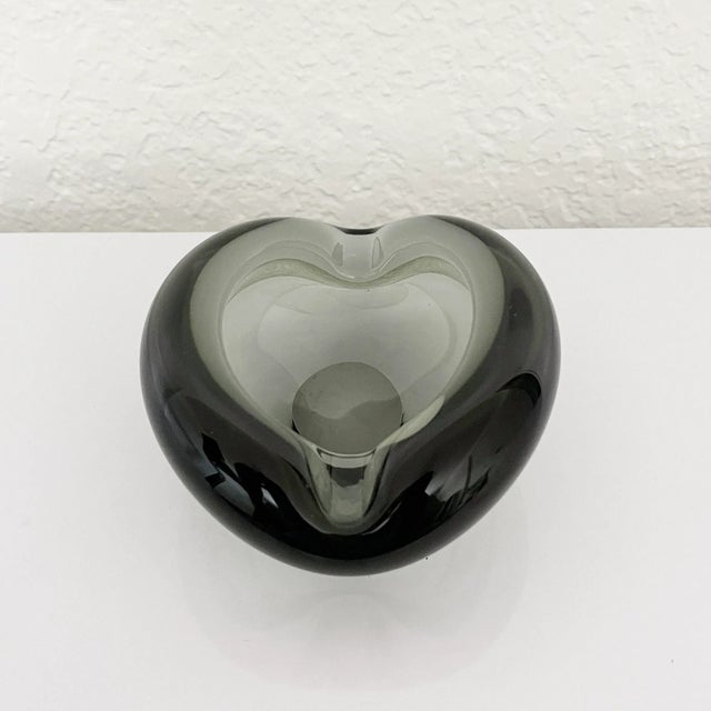 Heavy, handmade, Scandinavian modern ashtray or small trinket bowl formed of smoked transparent glass. Designed by Per...