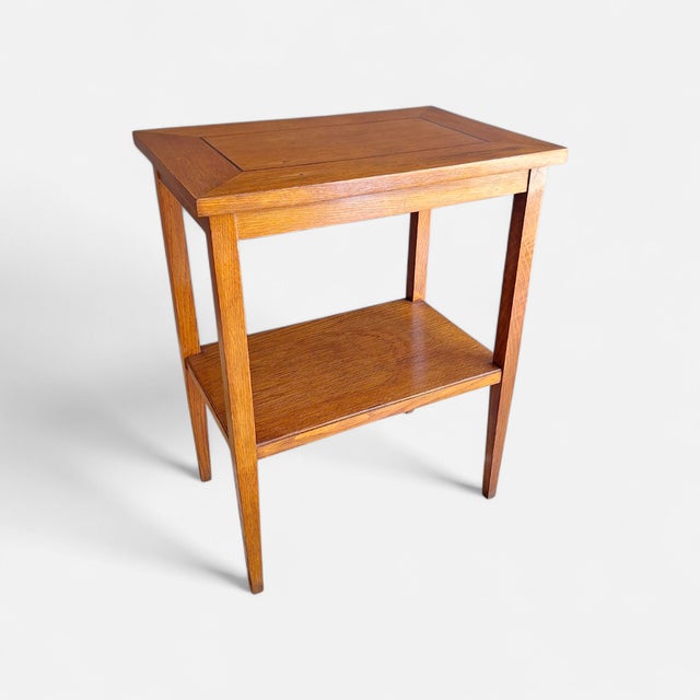 Side table made in Italy in the 1940s. The table is made of oak with a small inlay on the top. It has two shelves, the...