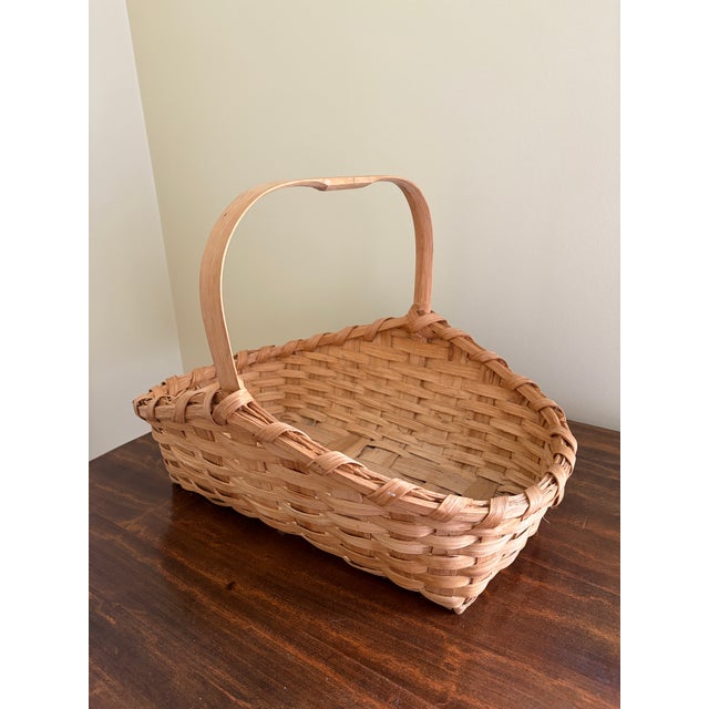 A beautifully handwoven late 20th century split oak basket with generous scale and a wonderfully time-softened surface....