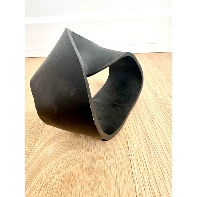 Striking hand-cast metal (iron or steel) Möbius ring sculpture with a continuous single-surface form, finished in a matte...