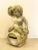 Garden sculpture made of cement from the 70's, it represents a putto with grapes sitting on a wine barrel, a metaphor for...