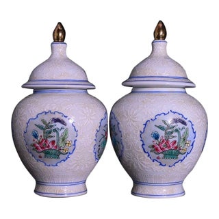 Pair of Chinese White Glazed Porcelain Jars With Floral Panels & Gilt Finials For Sale