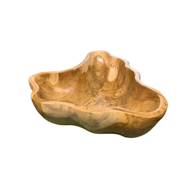 This teak live edge bowl is a unique piece showcasing the natural beauty of teak wood. Crafted by skilled artisans, its...