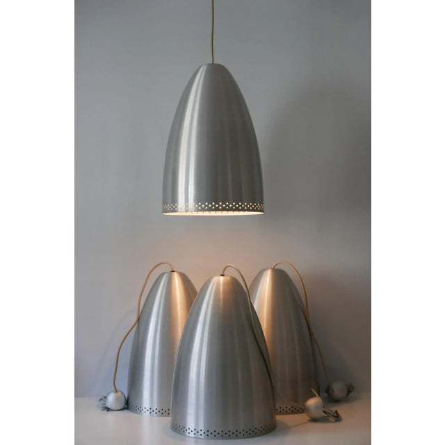 Elegant mid-century modern pendant lamps or hanging lights. Manufactured in germany around 1970s. executed in perforated...