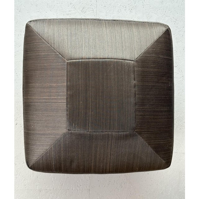 Elevate your décor with this chic pouf, featuring a black square pillow and sturdy iron legs. A perfect blend of comfort...