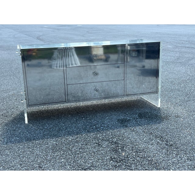 Beautiful Milo Baughman Style Lucite and mirrored chrome tall credenza that stands on three thick Lucite slabs in good...