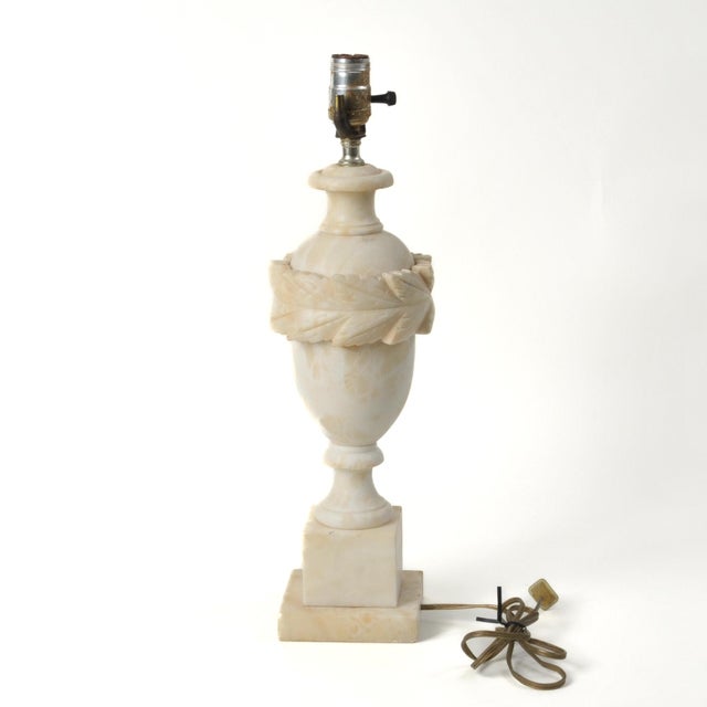Tastefully and classically designed vintage alabaster lamp with carved leaf detail around an urn shaped body. Larger size...