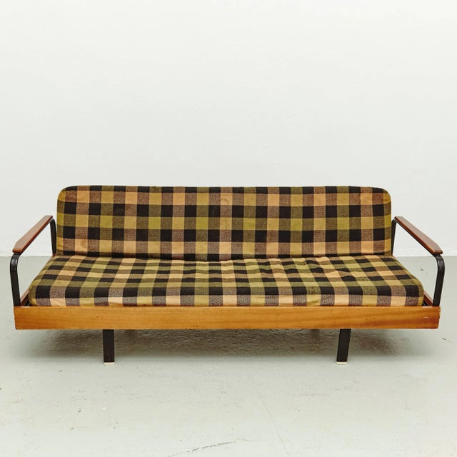 - Sofa manufactured in France circa 1950 - Designed in the manner of Jean Prouve - Lacquered metal legs and a wooden frame...