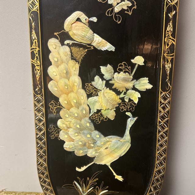 Striking pair of vintage Chinese black lacquer wall plaques featuring carved and inlaid hardstone birds and florals in...