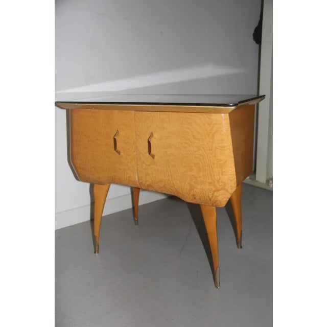 This set of 2 Italian nightstands are made of maple and brass with parts in colored glass.