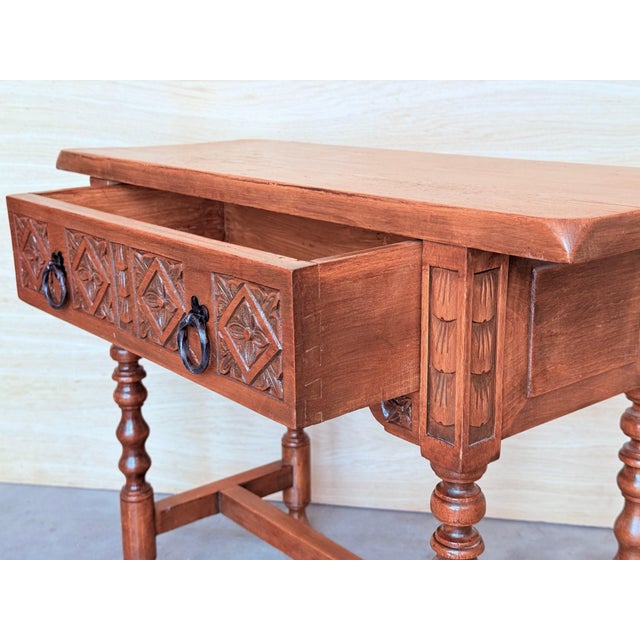 20th century Spanish nightstand or console table with one drawer and iron hardware. The table has a beautiful carved...