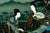 A finely hand-painted Chinese reverse painting on glass depicting two elegant court ladies examining a painted hand scroll...