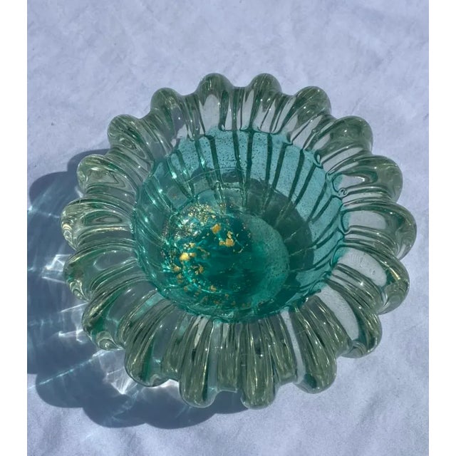 This is a vintage murano art glass bowl. The entire of the bowl is done in a beautiful thick clear glass. The interior of...