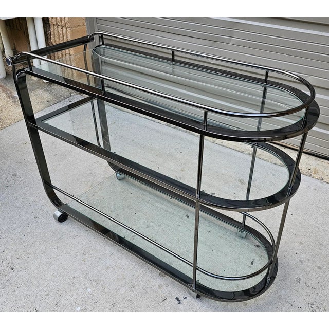 This classic and elegant bar cart designed in 1992 by the renowned Design Institute of America has vintage appeal with a...