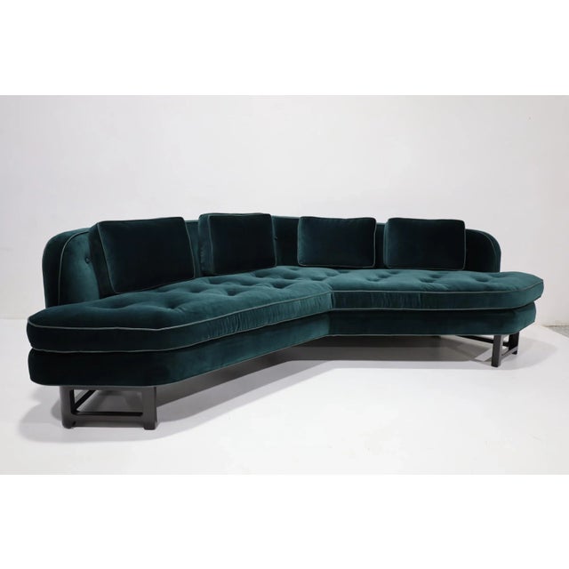 An outstanding Edward Wormley for Dunbar Janus Model 6329 Angle sofa newly upholstered in a Raf Simons teal velvet with...